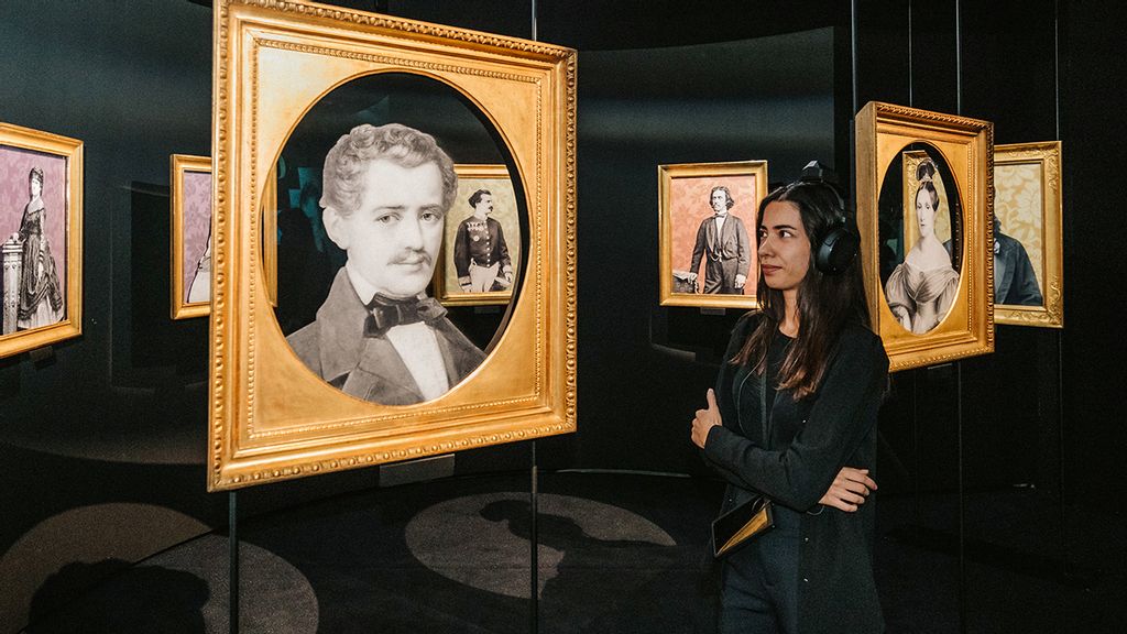 © Philipp Lipiarski Eine Frau sieht sich eine Portrait von Strauss an