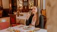 Frau bei einem Essen in einem historischen Hotel