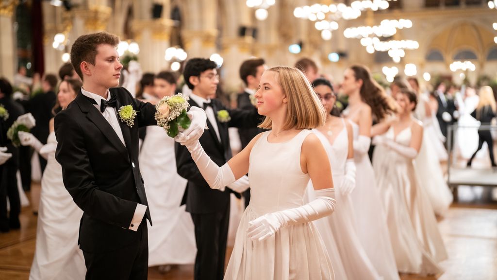 Ein junges Paar in Ballkleidung während eines Tanzes auf der Tanzfläche